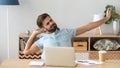 Tired sleepy man stretching, doing easy exercise at workplace Royalty Free Stock Photo