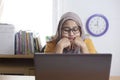 Tired Sleepy Muslim Businesswoman Waiting in Front of Her laptop Royalty Free Stock Photo