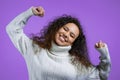 Tired sleepy woman yawns. Girl stretches hands up. Very boring, uninteresting. Violet studio background.