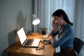 A tired Asian female college student is falling asleep while doing homework at a table Royalty Free Stock Photo