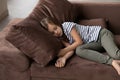 Tired small girl child sleep on sofa at home