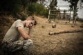 Tired soldier with hand on head sitting