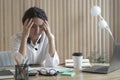 Tired spanish businesswoman with closed eyes sitting at workplace in office, suffering from headache Royalty Free Stock Photo