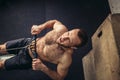 Tired sporty male workouts on power exercise machine in a gym club Royalty Free Stock Photo