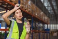 Tired stress woman staff worker sweat from hot weather in summer working in warehouse goods cargo shipping logistics industry Royalty Free Stock Photo