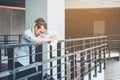 Tired or stressed businessman standing on the walkway after work