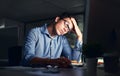 Tired, stressed businessman suffering from headache, working late night in the office. Serious, frustrated and Royalty Free Stock Photo