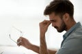 Tired stressed guy taking off glasses feeling eyestrain or headache Royalty Free Stock Photo