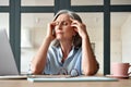 Tired stressed old mature business woman suffering from headache at work. Royalty Free Stock Photo