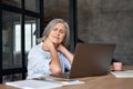 Tired stressed older mature business woman suffering from neck pain. Royalty Free Stock Photo