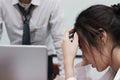 Tired stressed young Asian business woman disagreeing with angry boss in meeting room of office