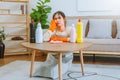 Tired stressed young Asian woman with headache doing spring cleaning chores in her living room at home overworked housekeeping Royalty Free Stock Photo