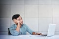 Tired and Stressed Young Businessman Sitting on Desk in Office with Computer Laptop. Exhausted Man Royalty Free Stock Photo