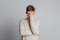 Tired stressed young man suffering from strong pain. Portrait of handsome guy feeling sick, having headache, nose pain, covering Royalty Free Stock Photo