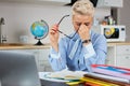 Tired stressed young teacher woman sitting at her desk with books in front laptop Royalty Free Stock Photo