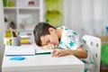 Tired student boy sleeping on table at home Royalty Free Stock Photo