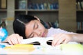 Tired student girl with books sleeping on the table. education, Royalty Free Stock Photo