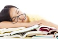 Tired student girl with glasses sleeping on the books Royalty Free Stock Photo