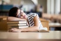 Tired student girl with glasses sleeping on the books Royalty Free Stock Photo