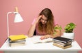 Tired student having a lot of work in a library. Too much work tired sleepy young woman sitting at her desk with books Royalty Free Stock Photo