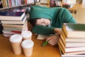 Tired student or man with books in library Royalty Free Stock Photo