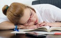 Tired student sleeping on the books instead of studying Royalty Free Stock Photo