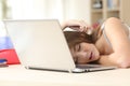 Tired student sleeping over laptop at home Royalty Free Stock Photo