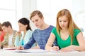 Tired students with textbooks and books at school Royalty Free Stock Photo