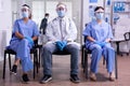 Tired team of doctors looking at camera with protection mask Royalty Free Stock Photo