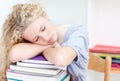 Tired teeenager sleeping in a library Royalty Free Stock Photo