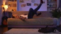 Tired teen male student coming home after lectures, lying down on couch, rest