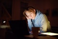 Tired teenager napping while studying at home with laptop and tablet pc at night. Online learning, distance lessons, freelance - Royalty Free Stock Photo