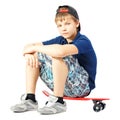 Tired teenager sitting on a skateboard Royalty Free Stock Photo