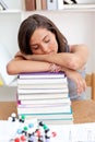 Tired teenager sleeping in a library