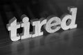 Tired, text words typography written with wooden letter on black background, life and business negativity