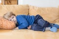 Tired toddler boy laying on couch