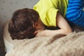 Tired toddler boy lying on the bed with his face down. Crying little kid Royalty Free Stock Photo