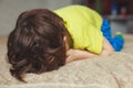 Tired toddler boy lying on the bed with his face down. Crying little kid Royalty Free Stock Photo