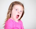 Tired toddler girl yawning on light background