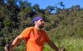 Tired trekker on forest landscape background. Wild nature view with male tourist. Man in treking or hiking outfit