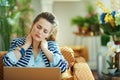 Tired trendy female having neck pain with laptop Royalty Free Stock Photo