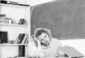 Tired tutor fall asleep at workplace. Woman tired in school classroom. Teacher exhausted after hard working day. School Royalty Free Stock Photo