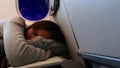 Tired tween girl sleeping on airplane