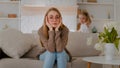 Tired upset Caucasian mother sitting on sofa at home sad frustrated stressed exhausted fatigued mom suffer headache with Royalty Free Stock Photo