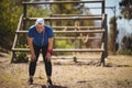 Tired woman bend down with hands on knees during obstacle course Royalty Free Stock Photo