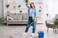 Tired woman cleaning floor with string mop Royalty Free Stock Photo