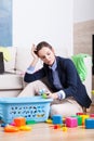 Tired woman cleaning up room from toys Royalty Free Stock Photo