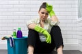 Tired woman doing house cleaning in bathroom. Fatigue, stress, cleanliness, home Royalty Free Stock Photo
