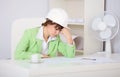 Tired woman engineer in workplace Royalty Free Stock Photo