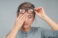 Tired woman in eyeglasses, covering eyes with hands Royalty Free Stock Photo